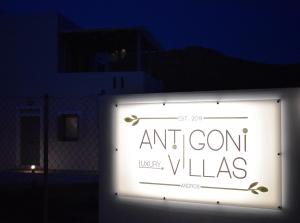 a sign that reads and corn villas in the dark at Antigoni Villas in Gavrio