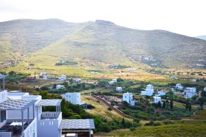 a view of a city with a mountain in the background at Antigoni Villas in Gavrio