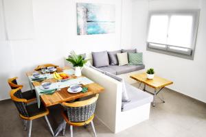 a living room with a table and a couch at Antigoni Villas in Gavrio