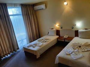 A bed or beds in a room at Hotel Silver - All Inclusive & Free Parking