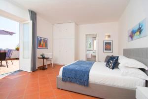 a bedroom with a bed and a living room at Villa dei Golfi in SantʼAgata sui Due Golfi