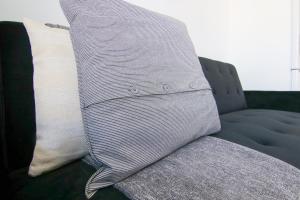 a couch with two pillows on top of it at Phaedrus Living Seaside Luxury Flat Athina 108 in Paphos