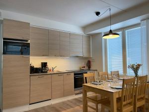 a kitchen with a wooden table and a dining room at Hotel Lost in Levi in Levi