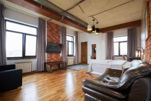 a living room with a bed and a couch at 7 days hotel in Almaty