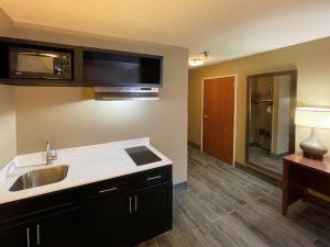 a kitchen with a sink and a microwave at Quality Inn & Suites I-40 East in North Little Rock