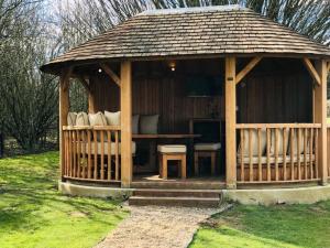 a wooden gazebo with a table and chairs at Holiday Inn Dover by IHG in Dover +84 photos