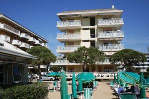 a building with a bunch of chairs in front of it at Diplomatic Apartment in Lido di Jesolo