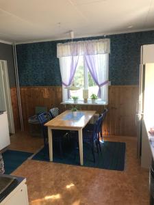 eine Küche mit einem Tisch und Stühlen sowie einem Fenster in der Unterkunft Stavred-gården in Bjärtrå