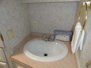 
a bathroom with a sink and a toilet at Pahrump RV Park & Lodging in Pahrump
