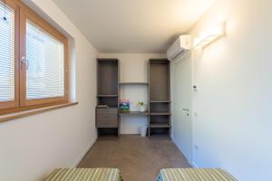 an empty room with a window and a closet at Agriturismo Umbrian Sunrise in Cannara