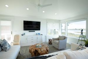 a living room with a couch and a tv at 87 Inlet Cove in Kiawah Island