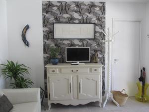a living room with a tv on top of a cabinet at Mazet de la Lavande in Uzès
