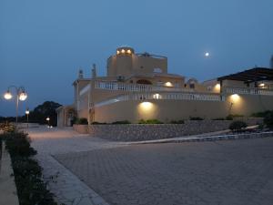 a large white building with lights on the side of it at Quinta Nova Vale Del Rey in Carvoeiro