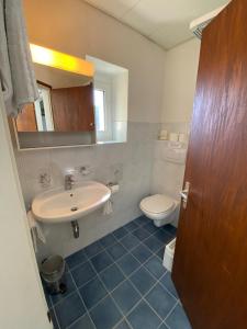 a bathroom with a sink and a toilet at Hotel Bellavista Cavigliano in Cavigliano