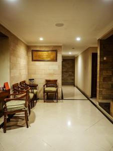 a hallway with chairs and tables in a building at Rhiz Guest House Tebet in Jakarta