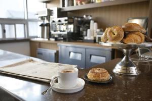 a table with a tray of pastries and a cup of coffee at Hotel Angeleno in Los Angeles