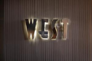 a sign that says war on a metal wall at Hotel Angeleno in Los Angeles