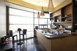 a kitchen with a bar and a table and chairs at Hotel Angeleno in Los Angeles