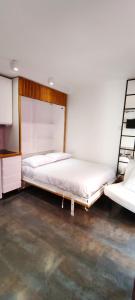 a bedroom with two beds and a desk and a bed at piso exterior centro sevilla in Seville