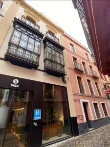 a store on a street next to a building at piso exterior centro sevilla in Seville