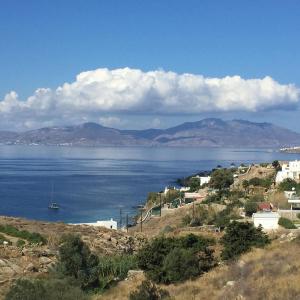 a view of a large body of water with mountains at Lilly's Sunset Suite in Mikonos