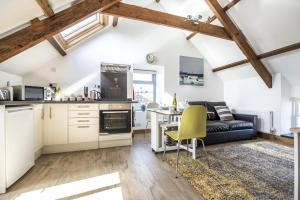 eine Küche und ein Wohnzimmer mit einem Tisch und einem Sofa in der Unterkunft Ashgrove Farm - 1 Bedroom Apartment - Llawhaden - Narberth in Narberth