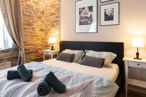 a bedroom with two beds and a brick wall at Garden Oasis in Zagreb