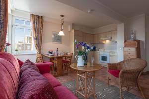 a living room with a couch and a kitchen at Ferienwohnung Bernstein #34 in Binz in Binz