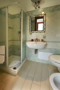 a bathroom with a sink and a shower at Affittacamere La Suite dei Graniti in Villasimius