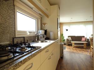 a kitchen with a sink and a stove top oven at Camping De Koehoorn in Meliskerke