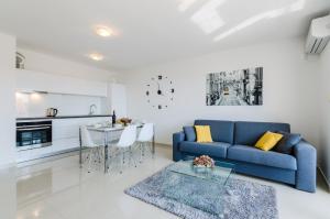 a living room with a blue couch and a table at Ilicevic Kralja Zvonimira in Crikvenica