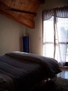 una camera con letto e finestra di Una mansarda luminosissima nel cuore di Stradella a Stradella