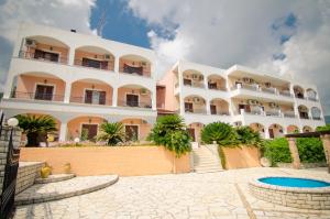 a large building with a pool in front of it at Margarita Aparthotel in Ipsos