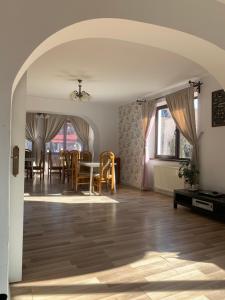 an archway in a living room with a table and chairs at Vila Codreanu in Bran