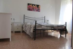 ein Schlafzimmer mit einem Bett und einem Bild an der Wand in der Unterkunft Appartamento La Cicala in Barga