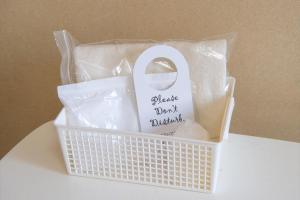 a plastic basket with a white door with a sign at Tabist Daibou Ichihara Mens Only in Ichihara