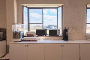 a kitchen with a counter with a large window at Tabist Daibou Ichihara Mens Only in Ichihara