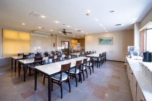 a large dining room with tables and chairs at Tabist Daibou Ichihara Mens Only in Ichihara