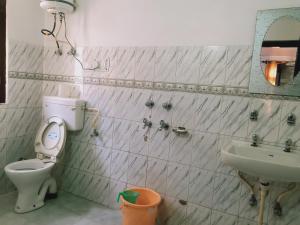 y baño con aseo y lavamanos. en Debbhumi Regency, en Sāngla