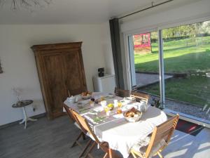 a dining room with a table and a large window at Les Chambres de Pascaline in Arrest +38 photos
