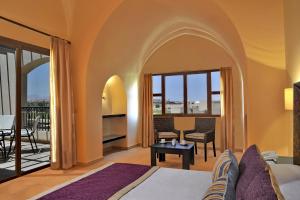 A bed or beds in a room at JAZ Neo Saraya Palms