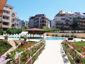 a resort with a swimming pool and some flowers at Apartments Perla Beach - Ivanovi in Primorsko