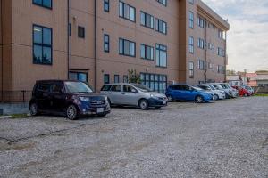 a row of cars parked in front of a building at Tabist Daibou Ichihara Mens Only in Ichihara