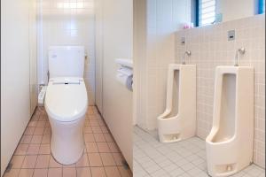 a bathroom with a toilet and two urinals at Tabist Daibou Ichihara Mens Only in Ichihara