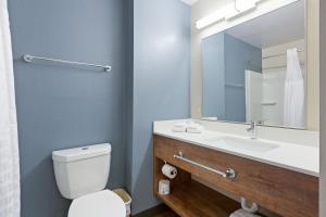 a white toilet sitting next to a sink in a bathroom at Extended Stay America - Miami - Airport - Doral - 25th Street in Miami