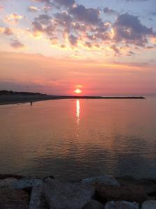 a sunset over a body of water at Hotel Berna in Eraclea Mare