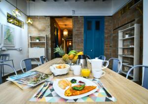 a table with a plate of food on it at Botánica Casa Hotel in Medellín