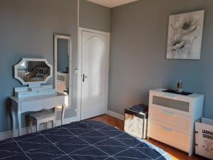 - une chambre avec une coiffeuse et un miroir dans l'établissement MARIELU 2, à Pouilly-sur-Loire
