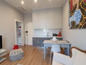 a kitchen with a blue table in a room at Foscolo 27 a 100 m dal mare in Viareggio