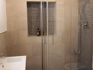 a shower with a glass door in a bathroom at Foscolo 27 a 100 m dal mare in Viareggio +12 photos